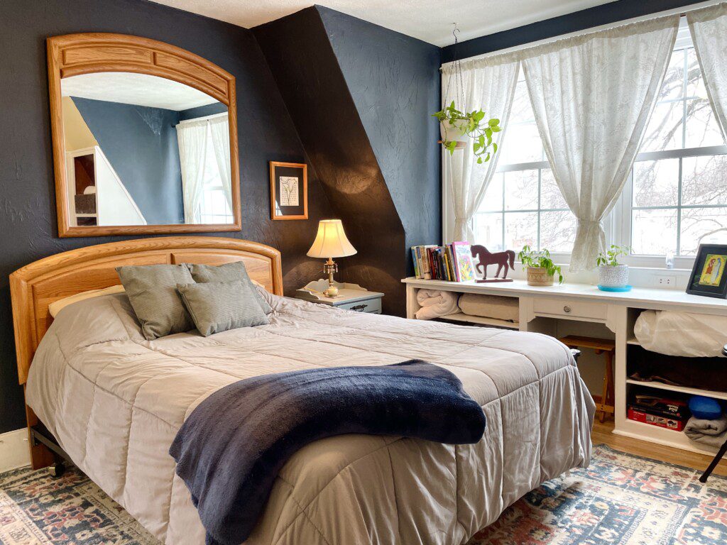 Your cozy haven for the night 🌙🐴 — warm lamp glow, classic wood furniture, and charming country décor give this bedroom a welcoming, homey vibe you'll love waking up to every morning.