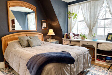 Your cozy haven for the night 🌙🐴 — warm lamp glow, classic wood furniture, and charming country décor give this bedroom a welcoming, homey vibe you'll love waking up to every morning.