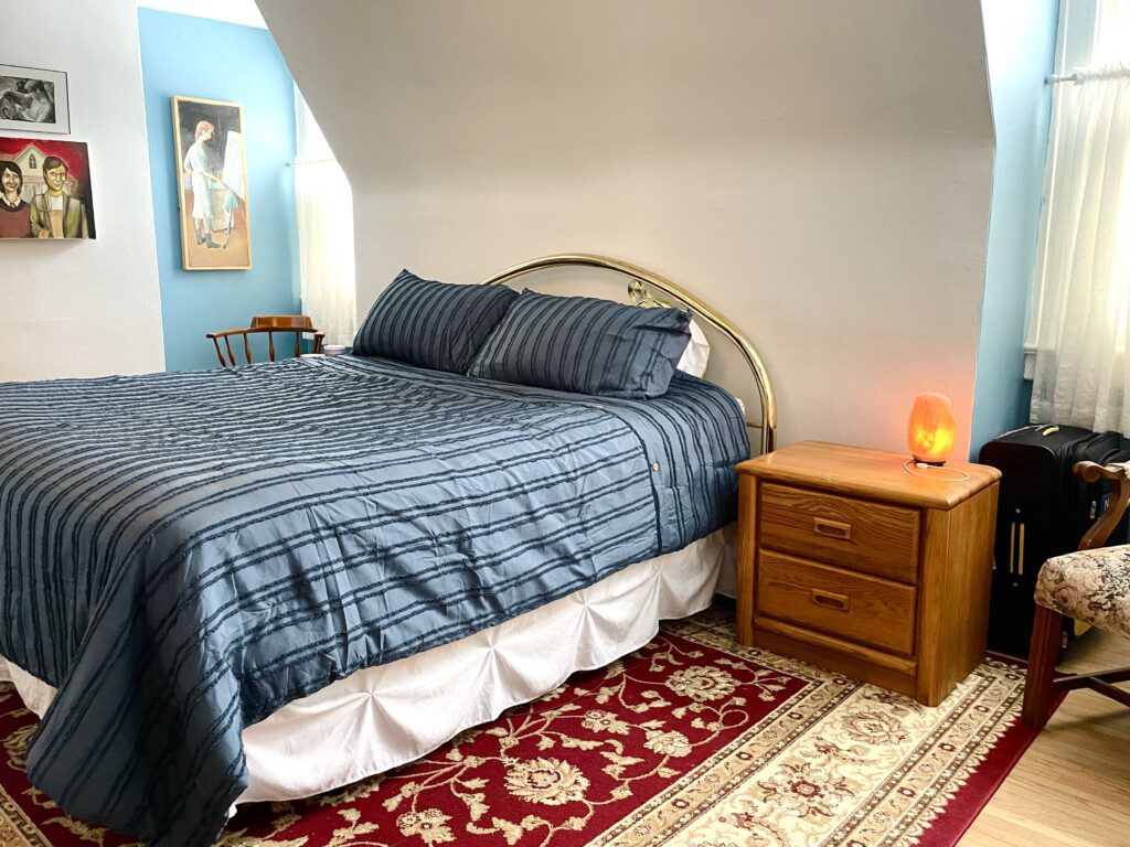 Drift off to a perfect night's sleep in this cozy, thoughtfully styled bedroom 😴💙 — plaid bedding, warm lamplight, and classic wood furnishings create a space that feels like pure rest.