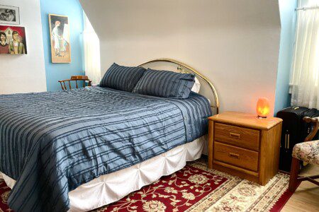 Drift off to a perfect night's sleep in this cozy, thoughtfully styled bedroom 😴💙 — plaid bedding, warm lamplight, and classic wood furnishings create a space that feels like pure rest.