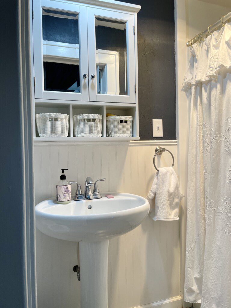 A fresh, clean bathroom ready for your morning routine 🚿🤍 — classic white tiling, a bright pedestal sink, and a welcoming shower to start every day feeling refreshed and renewed.