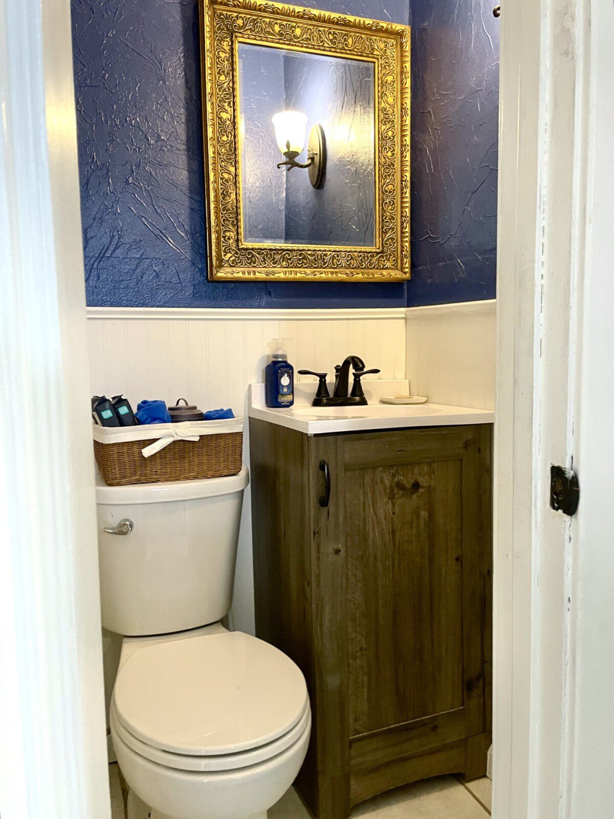 Your private spa experience awaits 🛁✨ — rich wood tones, gold accents, and cool navy walls create a sophisticated bathroom where you can unwind in style every single day of your stay.