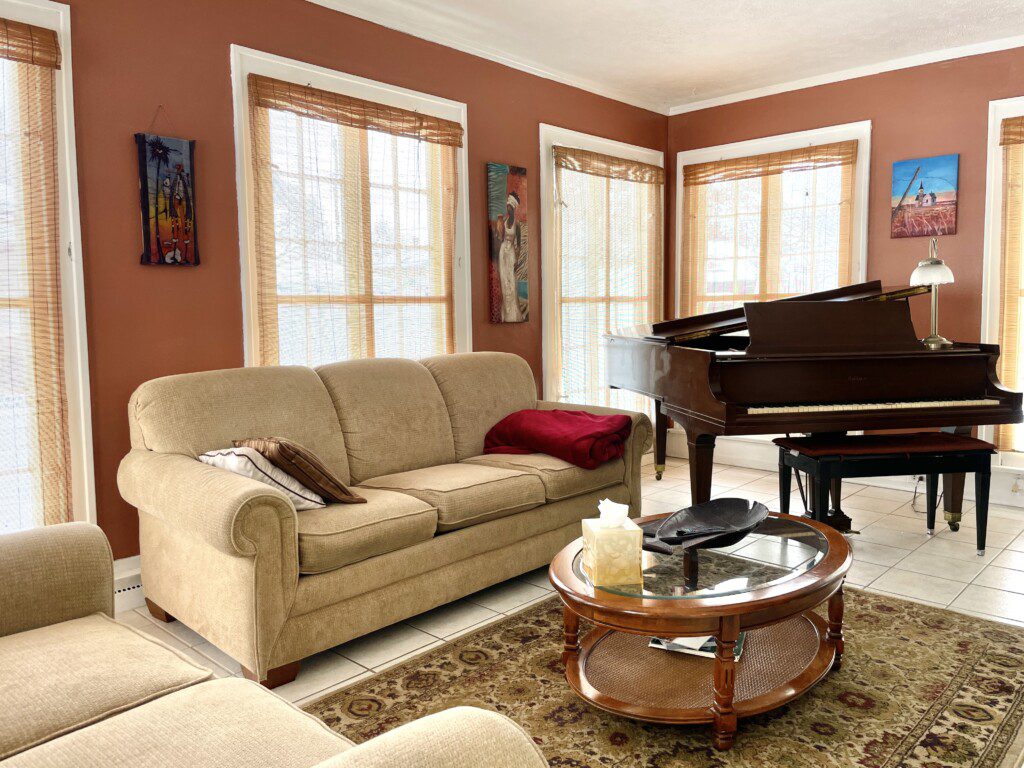 Your living room, your rules 🛋️🎶 — sink into the plush sofa, soak in the warm, golden light, and let the music of the grand piano set the tone for an unforgettable evening in.