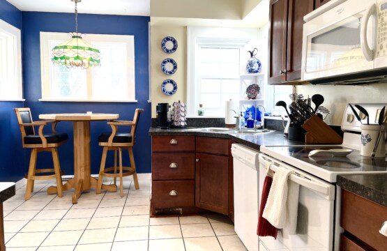 Whip up your favorite meals in this stunning teal kitchen 🍳💚 — beautiful cabinetry, elegant pendant lighting, and a stylish bar area make cooking here feel like a delightful experience.